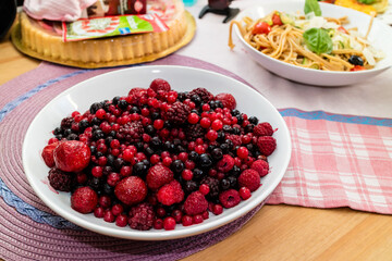 Assortment of Fresh Forest Berries on a Rustic Wooden Surface
