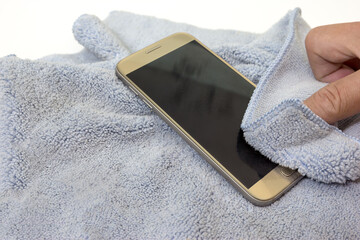 smartphone cleaning dirty screen with blue microfiber fabric