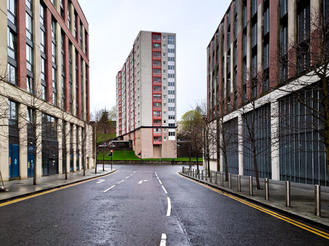 A large apartment block at the end of a road