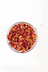 Tea made from tea rose petals in a glass bowl on white background