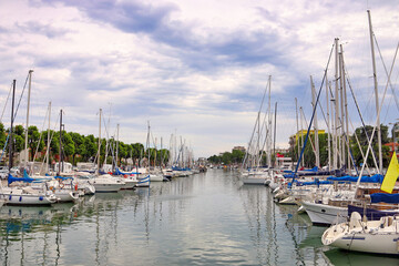 Yachts and sailboats moored in the canal in Rimini Italy - 798840782