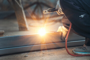 Men hands wear protective glove Hot flame metal work cutting fire iron workshop. Locksmith use...