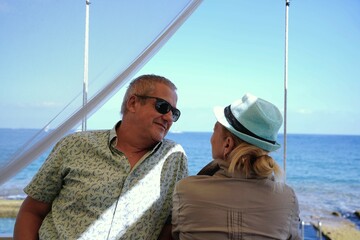 husband and wife talking with intimacy in the spanish coast. Carefree family