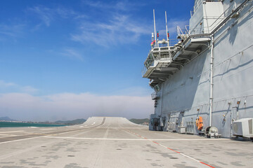Runway track on deck of the aircraft carrier with blue sky
