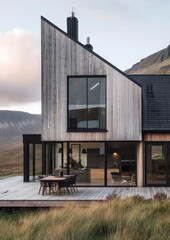 Fototapeta na wymiar Modern house in the highlands, timber cladding and black windows
