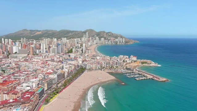 Benidorm, Spain: Aerial view of beach Playa de Poniente (West Beach) in famous summer tourist resort by Mediterranean Sea, summer day with blue sky - landscape panorama of Europe from above
