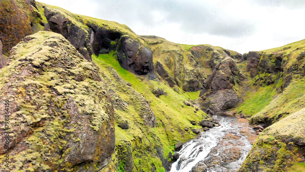 Sticker aerial view of beautiful stjornarfoss waterfall on a wet rainy day