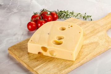 Maasdam cheese brick over board