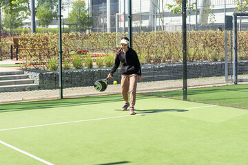  little girl playing padel and hitting the ball with his racket outdoors sports concepts