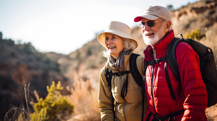 Fototapeta premium Mature caucasian couple on vacation, having a hike in the spring mountains, spending time together after retirement together travelling - tourism, pension concept