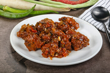 Manchurian chicken with sauce and spices