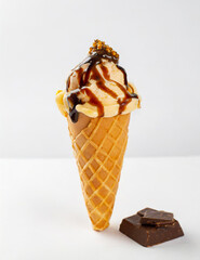 delicious ice cream in a waffle cone is topped with chocolate topping and caramel. Generative AI