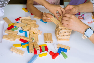 International Children Day. Beautiful Latino children playing with blocks on a white table. Playful, fun and thinking games. Happy children at home. - obrazy, fototapety, plakaty