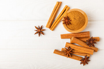 Cinnamon sticks and anise on a textured background. Cinnamon roll and star anise. Spicy spice for...