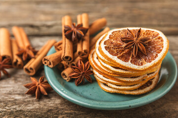Cinnamon sticks and anise on a textured background. Cinnamon roll and star anise. Spicy spice for baking, desserts and drinks. Fragrant ground cinnamon.Place for text. copy space.
