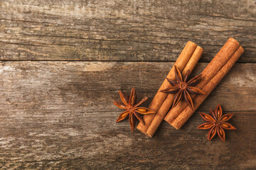 Cinnamon sticks and anise on a textured background. Cinnamon roll and star anise. Spicy spice for baking, desserts and drinks. Fragrant ground cinnamon.Place for text. copy space.
