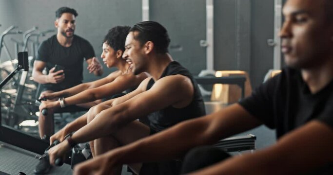 Exercise, rowing machine and coach with group in gym for wellness, sports or body health. Instructor, club and people workout on ergometer for fitness, muscle and cross training for cardio together