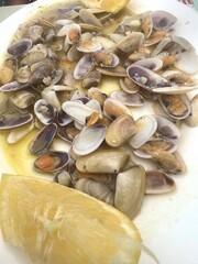 A plate of food with a lemon wedge on it