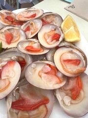 A plate of seafood with a few pieces of lemon and lime