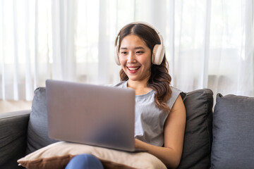 Naklejka premium Young smiling asian woman happy relax use laptop conference work,learning, education, shopping, study online, webinar, online marketing, business, blog, digital internet advertising at home