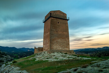 Tower of the medieval Taibilla castle in Nerpio, Albacete, Castilla la Mancha, Spain in a rocky setting at dawn