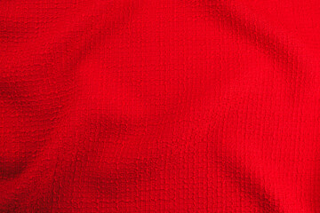 Texture of draped wool red fabric, top view, textured background.