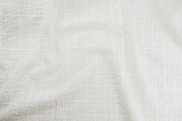 Texture of draped wool white fabric, top view, textured background.
