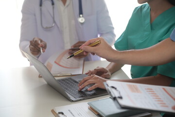 Medical Team Meeting Around Table In Modern Hospital