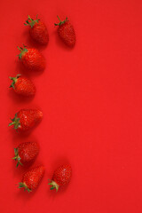 Strawberries on a red background.