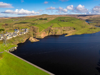 Aerial image of Naden Valley in Rochdale, Greater Manchester showing a modern village next to the greenbooth reservoir. 
