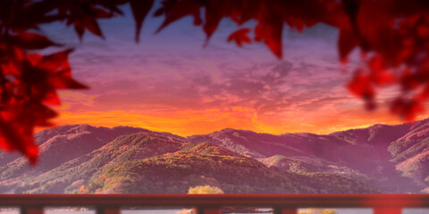 Mountain background. Sunset over hills. Red maple leaves. View point of mountains. Picturesque...