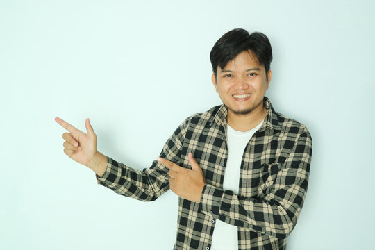 Young Asian man in shirt showing right and left fingers to the right side
