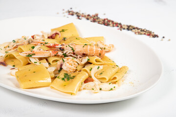 Paccheri allo scoglio is a italian food dish with pasta, seafood, shellfish and cherry tomatoes.