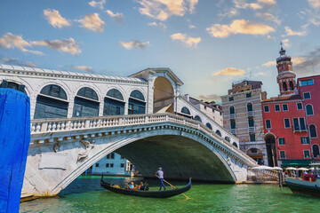 View of the Rialto Bridge and gondolas of the Grand Canal on a sunny day in Venice, Italy