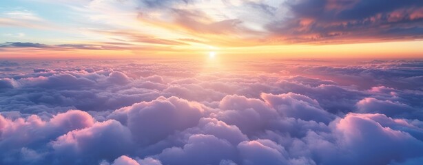 Beautiful sunset and cloudy sky from aerial view. Airplane view above clouds, panoramic banner...