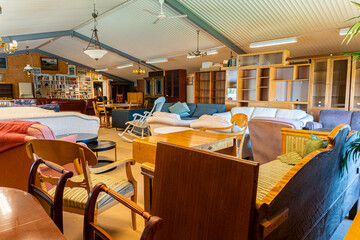 A big furniture store, second-hand. A lot of different furniture in the warehouse.
