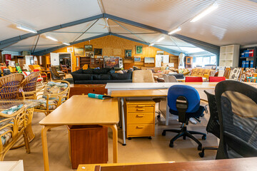 A big furniture store, second hand. A lot of different furniture in the warehouse.