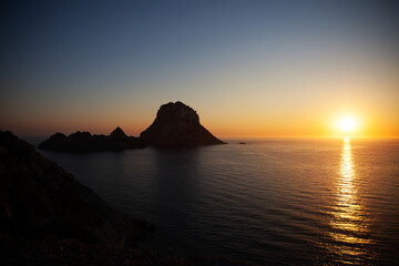 Fototapeta premium sunset over the sea of ibiza from a cliff