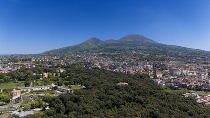 Fototapeta na wymiar Aerial view of Mount Vesuvius from the Royal Park of Portici. Ercolano and Portici lie at the foot of the volcano