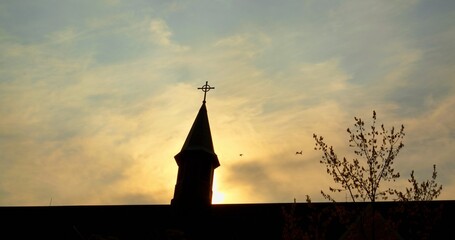 Catholic church's silhouette against vibrant evening sky, echo essence of faith and religion....