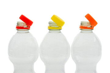 Tethered caps on small beverage bottles. Mandatory attached cap on plastic bottle in European Union. Ensuring that bottles and caps recycled together and loose caps no longer end up in environmen