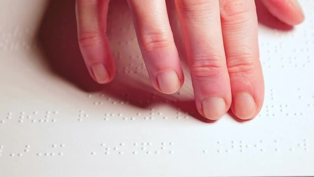 Blind woman reading text in braille language