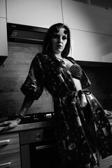 Naklejka premium Portrait of a young beautiful girl in the form of a demon. Black and white photo.