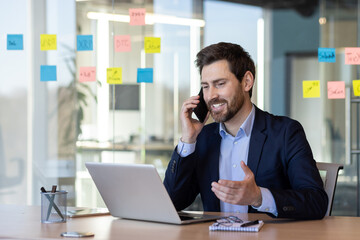 Smiling happy boss talking on the phone, businessman satisfied with the results of negotiations...