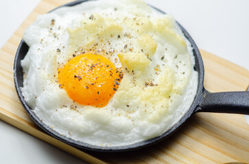 A cloud egg with a sprinkle of pepper on top