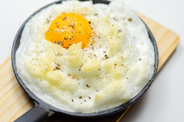A cloud egg with a sprinkle of pepper on top