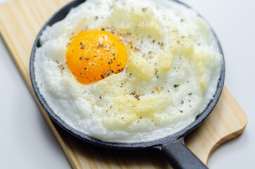 A cloud egg with a sprinkle of pepper on top