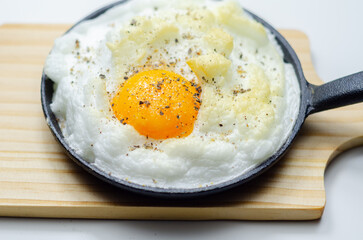 A cloud egg with a sprinkle of pepper on top
