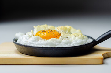 A cloud egg with a sprinkle of pepper on top