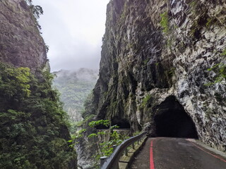 Taroko, Taiwan - 11.26.2022: Swallow Grotto Trail with no people passing through marble cliffs in the narrow Liwu River gorge in the mist before the 403 earthquake during the pandemic on a rainy day